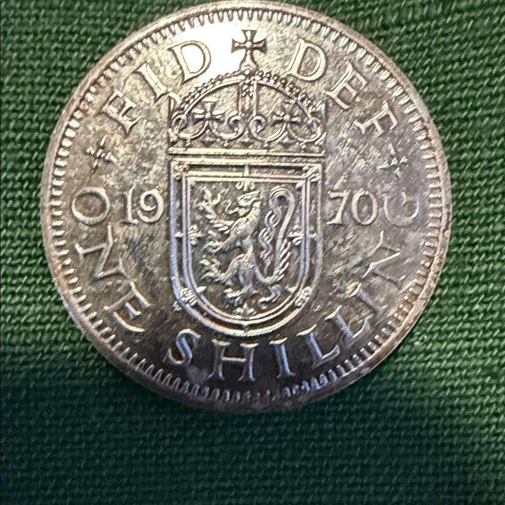 Mint Silver-Colored One Shilling Coin on Green Textile